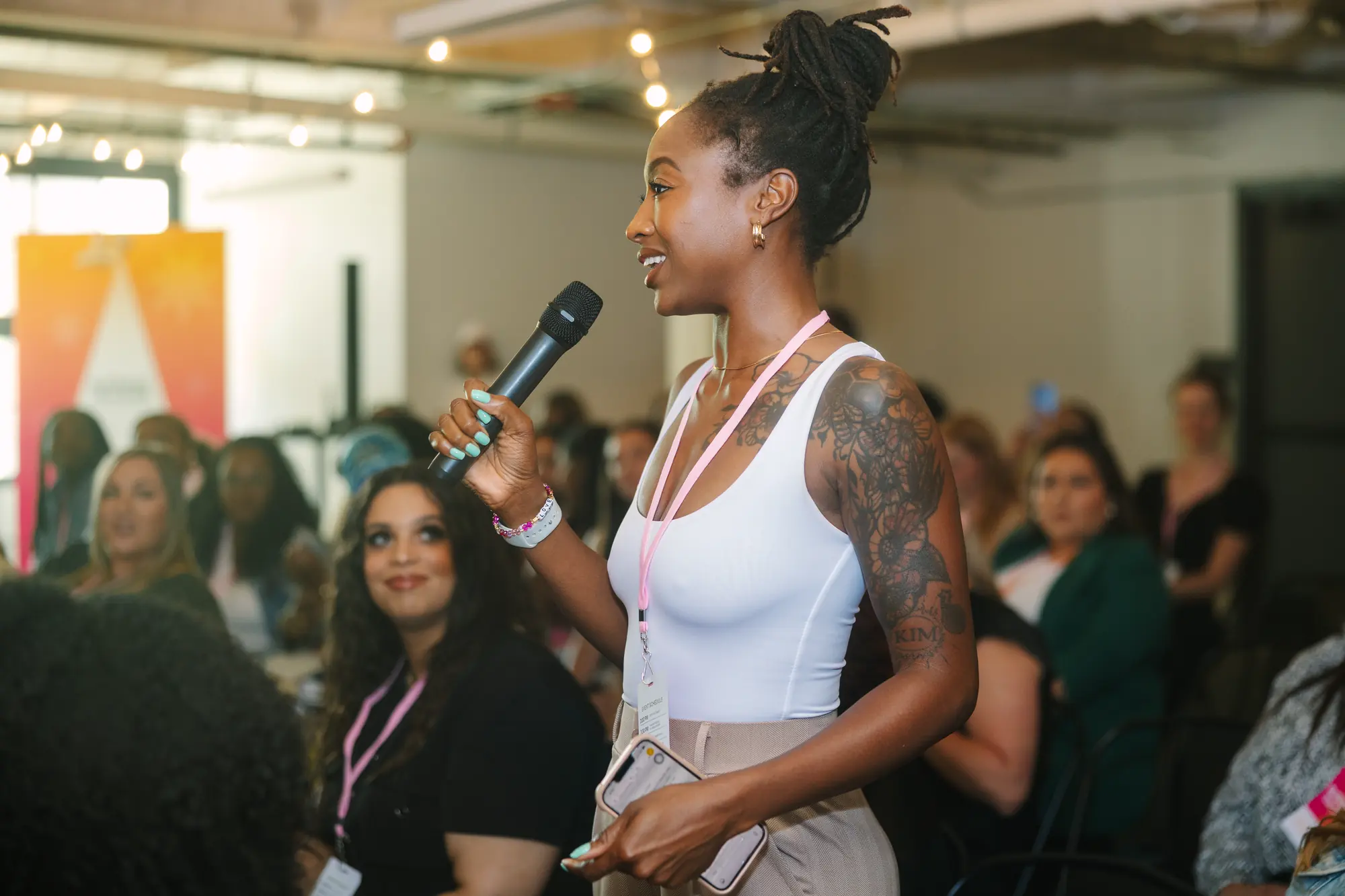 A speaker with a handheld microphone at a business event
