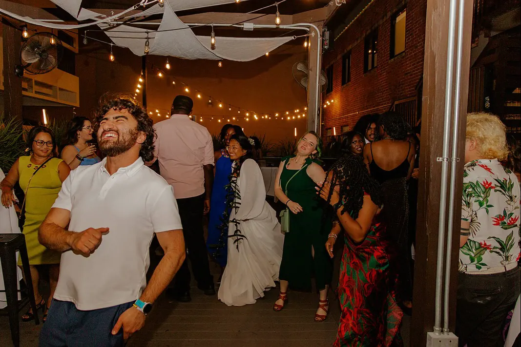 Guests dancing under string lights
