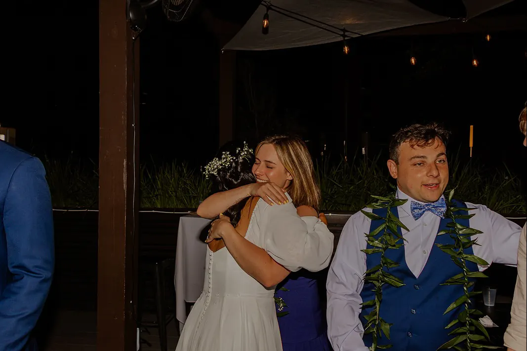 Guests hugging at a reception