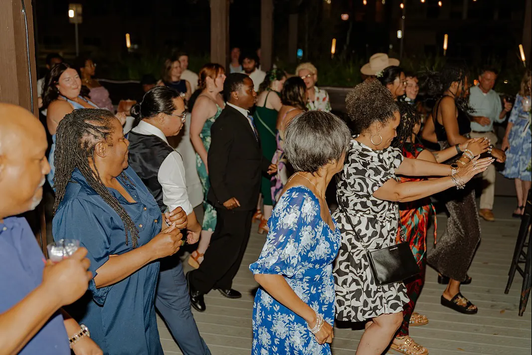 A packed dance floor at a wedding reception